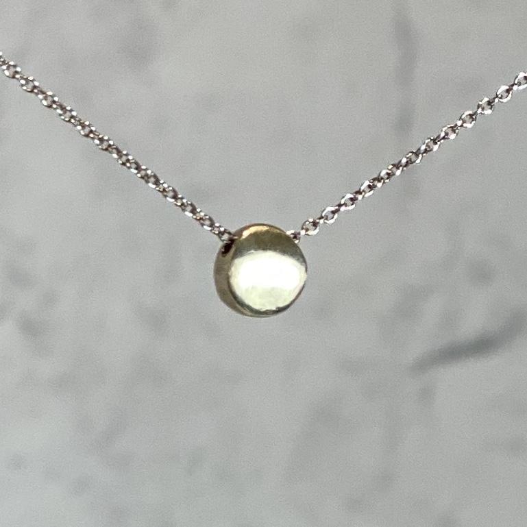 14k Gold Tiny Circle Necklace by Philippa Roberts on a silver chain